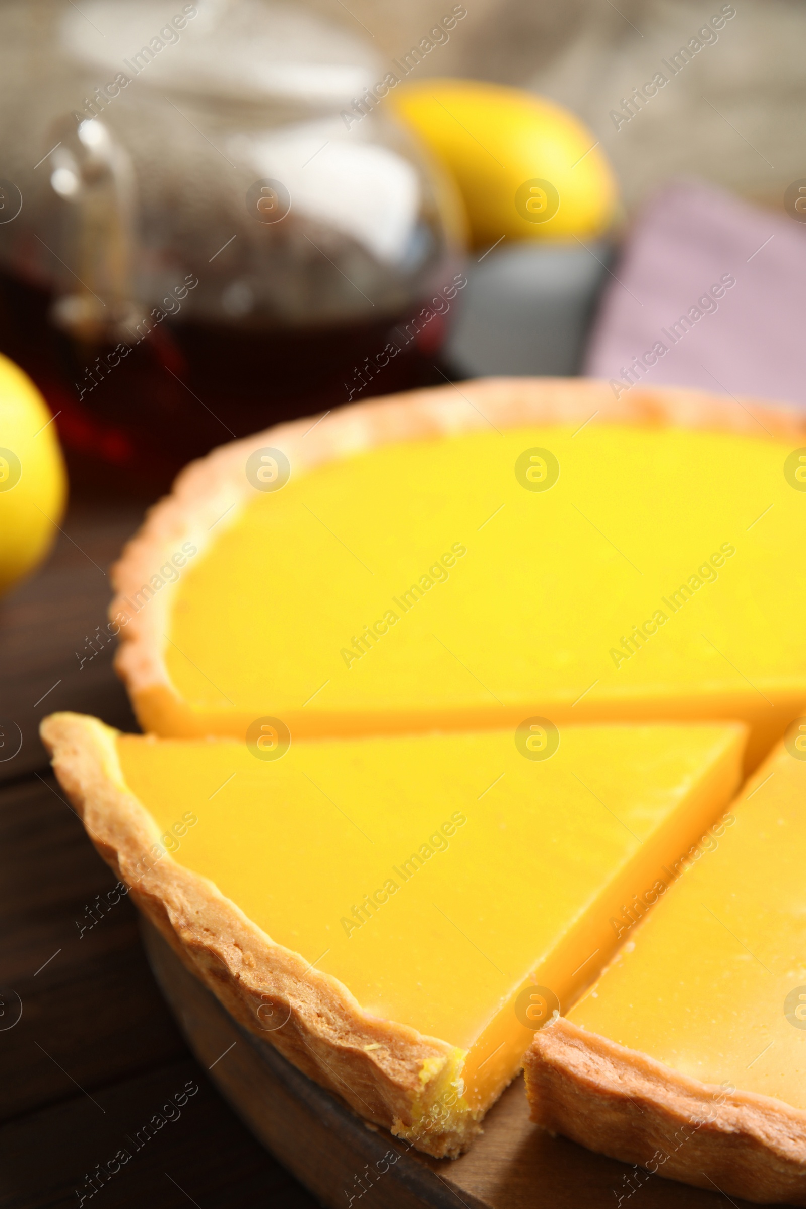 Photo of Delicious homemade lemon pie on wooden table, closeup