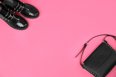 Pair of stylish ankle boots and bag on pink background, flat lay. Space for text