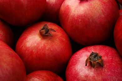 Many fresh ripe pomegranates as background, closeup