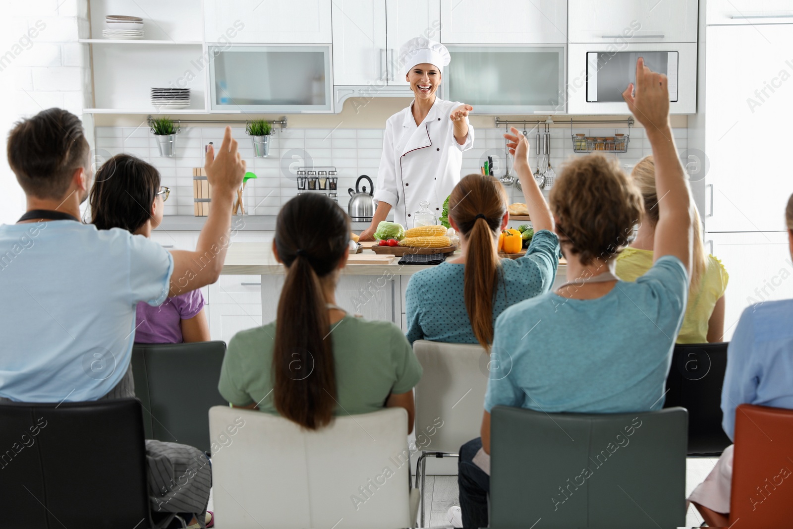 Photo of Group of people and female chef at cooking classes