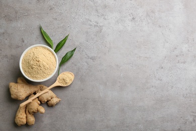 Photo of Dry ginger powder, fresh root and leaves on grey table, flat lay. Space for text