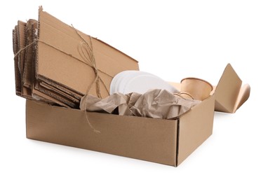 Photo of Cardboard box with waste paper isolated on white
