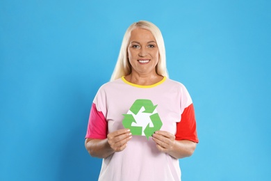 Photo of Woman with recycling symbol on blue background