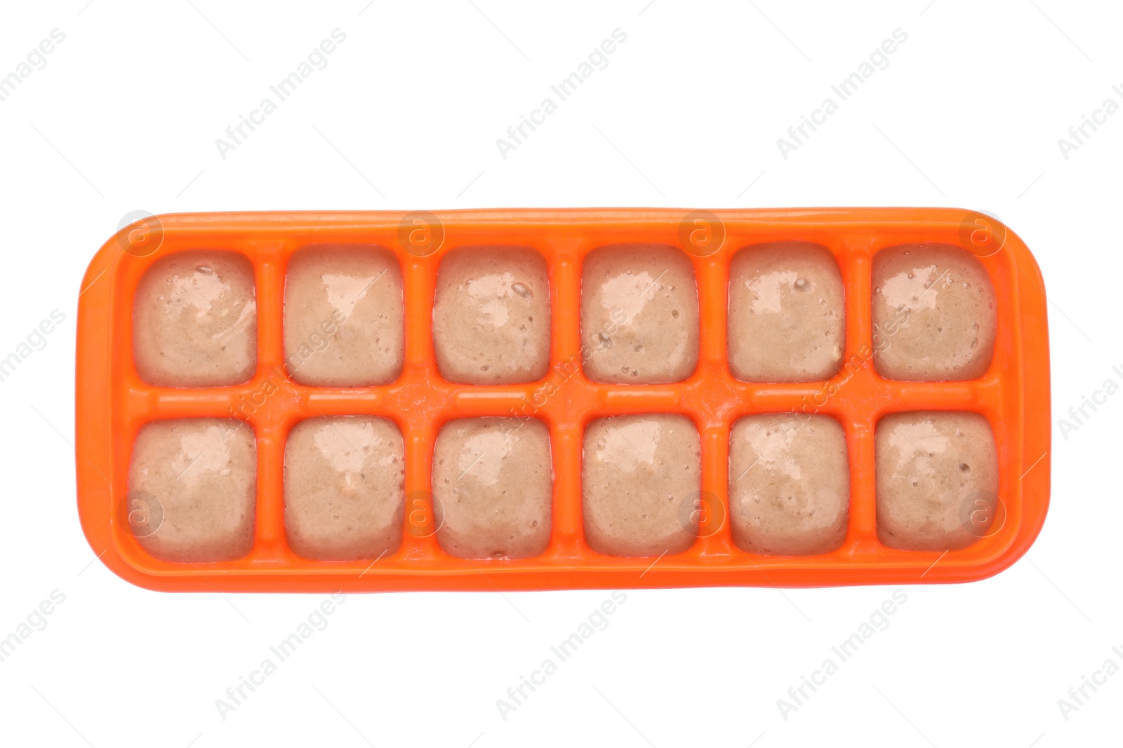 Photo of Banana puree in ice cube tray isolated on white, top view