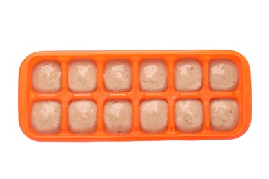 Photo of Banana puree in ice cube tray isolated on white, top view