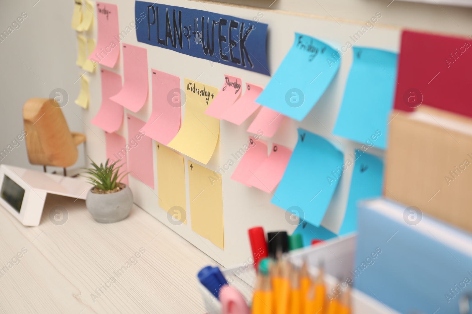 Photo of Business process planning and optimization. Workplace with colorful paper notes and other stationery on table, closeup