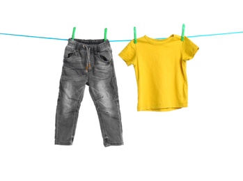 Photo of Child clothes on laundry line against white background