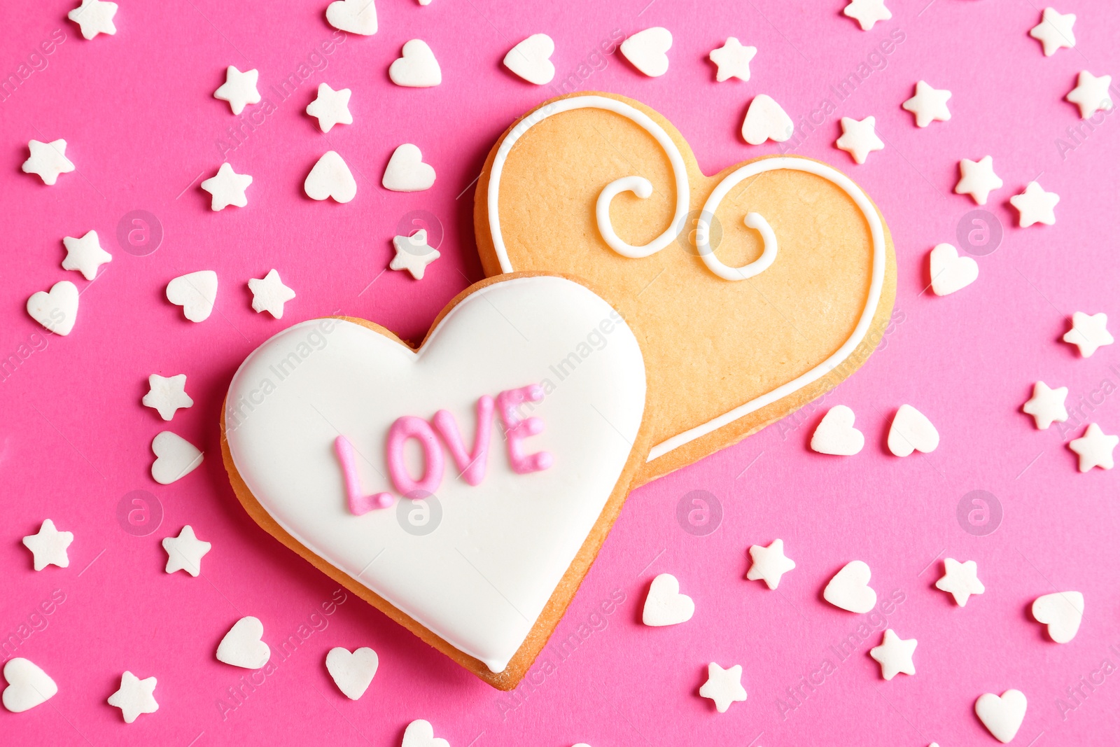 Photo of Composition with decorated heart shaped cookies on color background, top view. Valentine's day treat