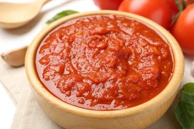 Homemade tomato sauce in bowl on white table, closeup