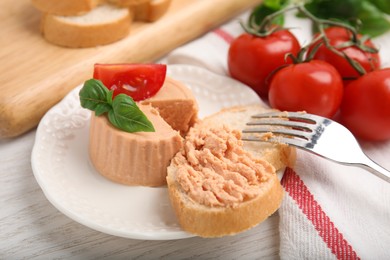 Photo of Fresh bread with delicious meat pate on white wooden table, closeup