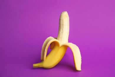 Photo of Fresh banana on purple background. Sex concept