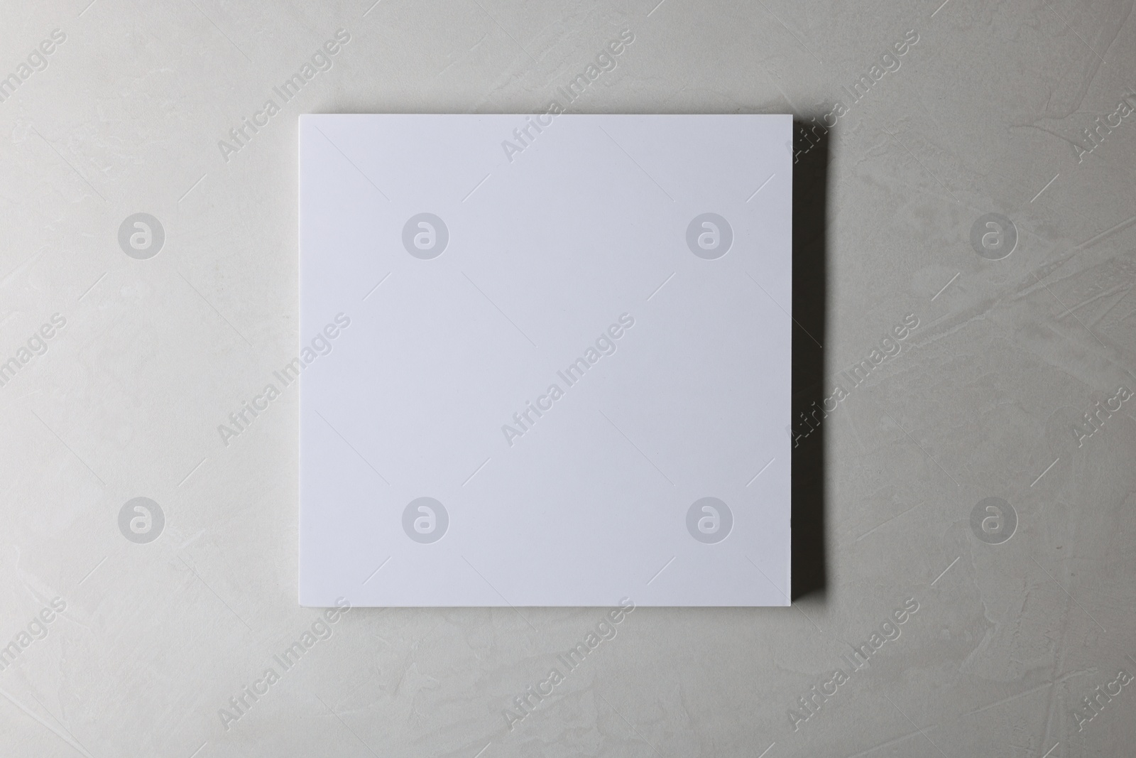 Photo of Blank paper sheets on grey textured background, top view. Mockup for design