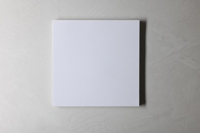 Photo of Blank paper sheets on grey textured background, top view. Mockup for design