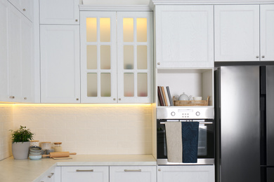 Photo of Modern kitchen interior with stylish white furniture