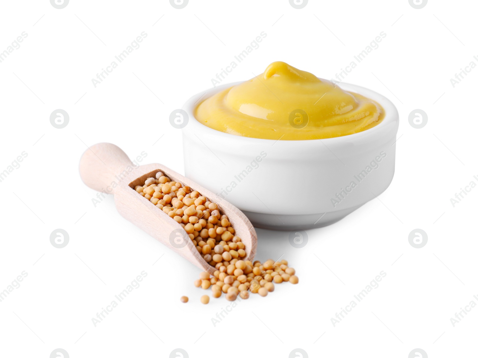 Photo of Bowl of delicious mustard and scoop with seeds on white background