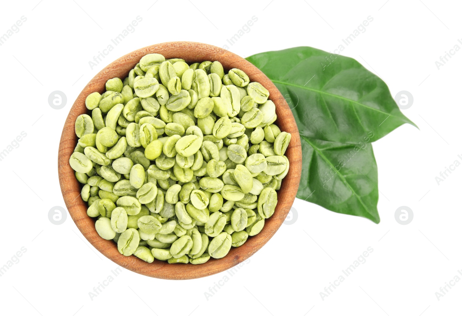 Photo of Wooden bowl with green coffee beans and fresh leaves on white background, top view