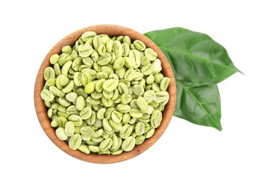 Wooden bowl with green coffee beans and fresh leaves on white background, top view