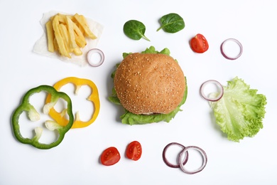 Composition with burger and ingredients on white background, top view