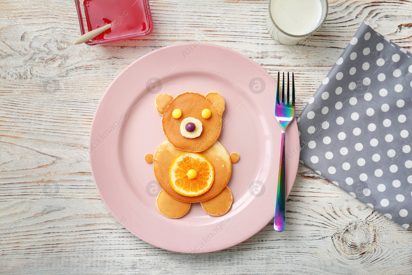 Photo of Flat lay composition with pancakes in form of bear on wooden background. Creative breakfast ideas for kids