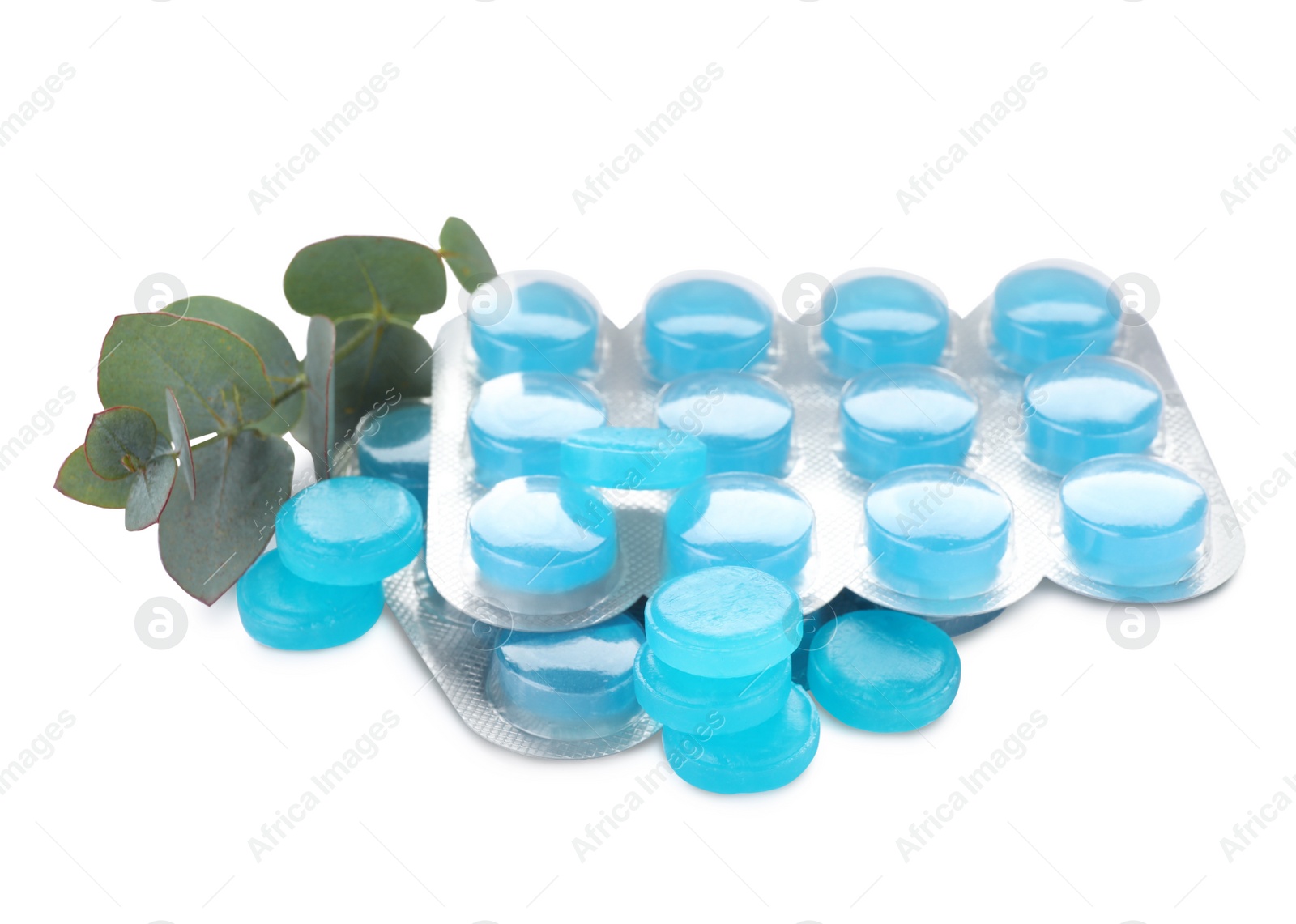 Photo of Many light blue cough drops and eucalyptus on white background
