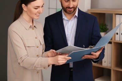 Photo of Businesspeople working together with documents in office