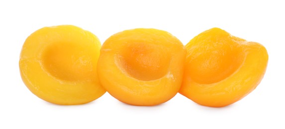 Photo of Sweet juicy canned peach halves isolated on white