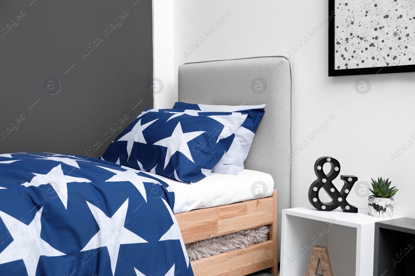 Photo of Bed with stylish linens in children's room