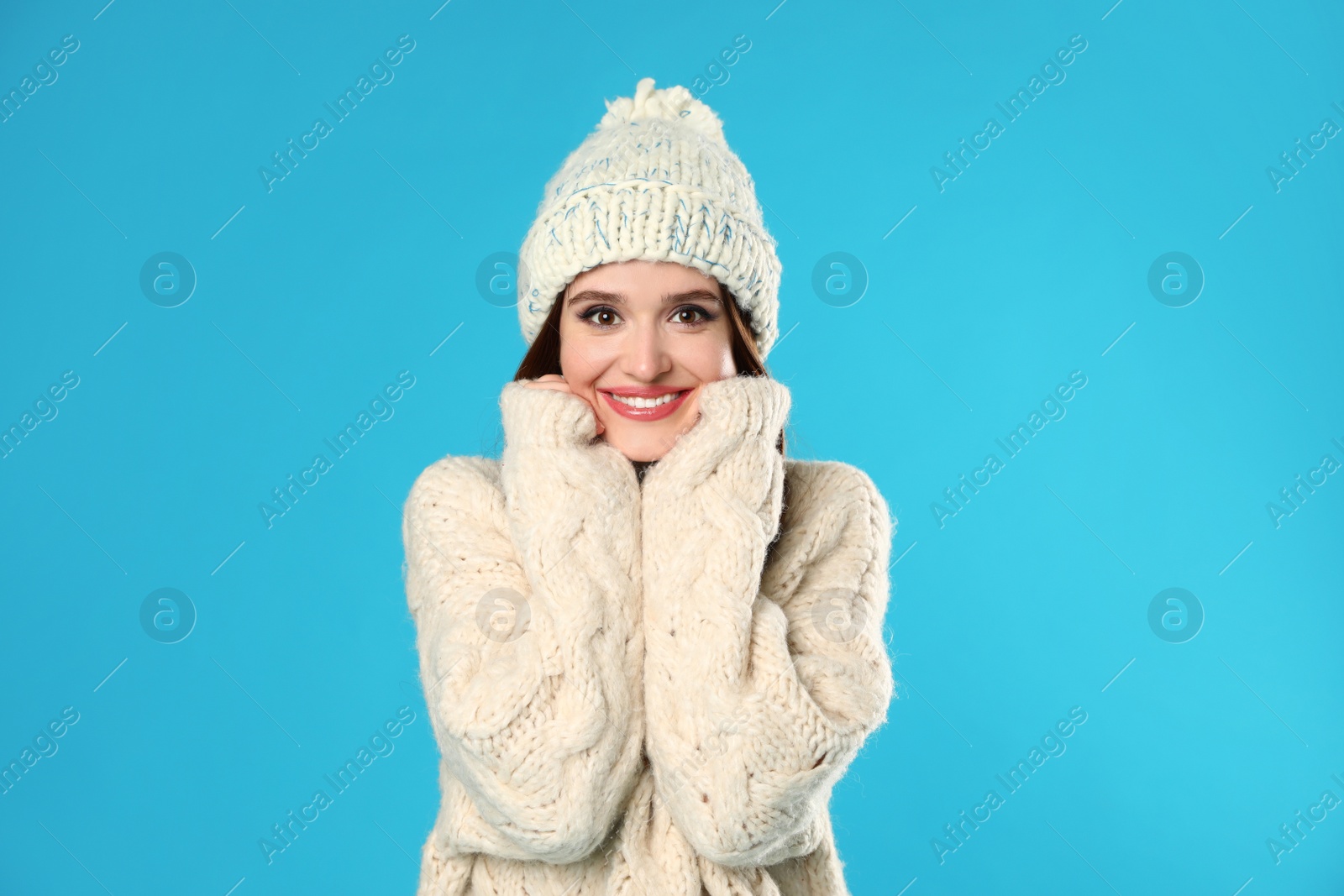 Photo of Young woman wearing Christmas sweater on blue background