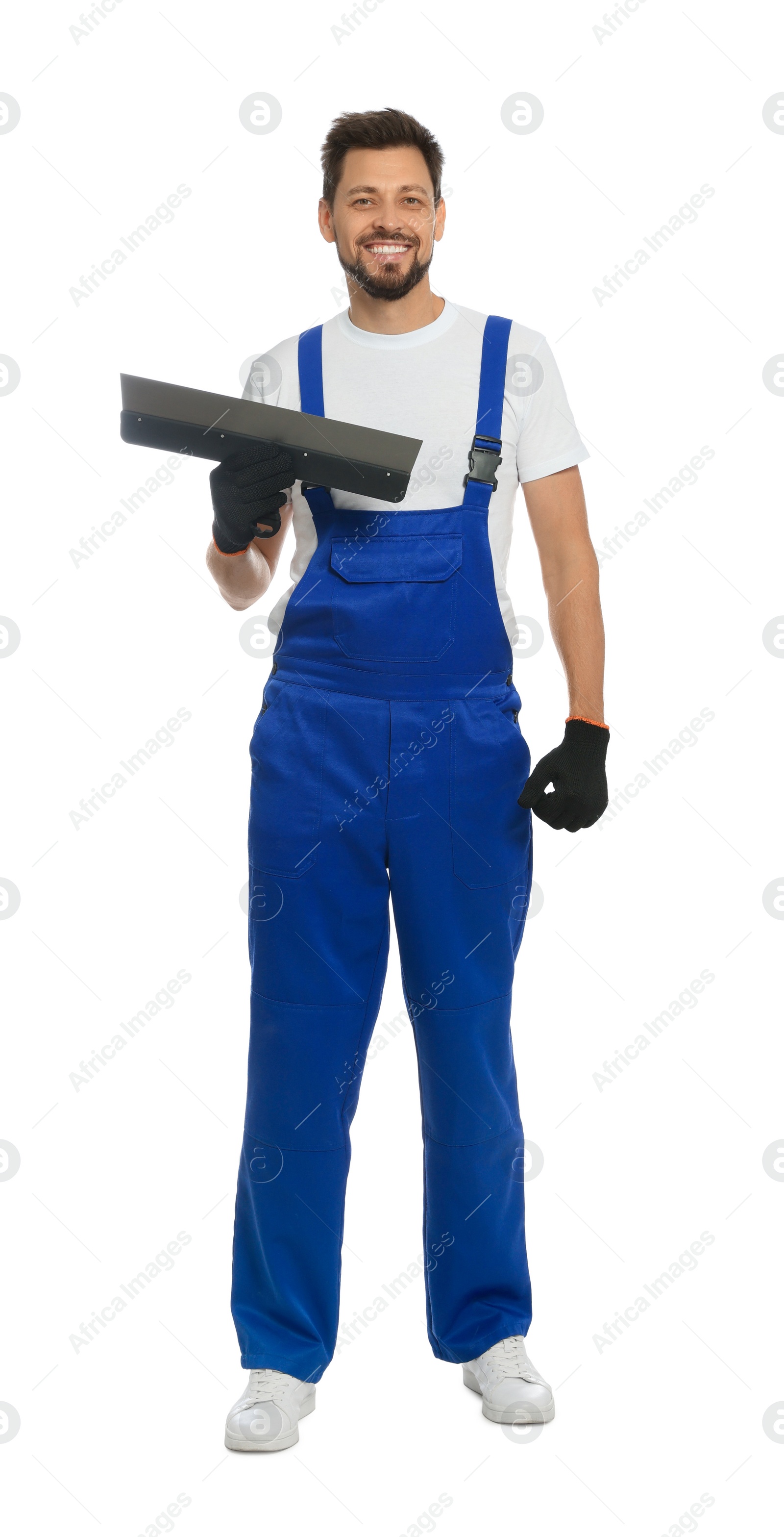 Photo of Professional worker in uniform with putty knife on white background