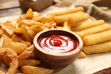 Photo of Different snacks and tasty ketchup on table, closeup