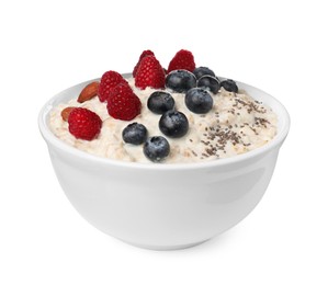 Tasty boiled oatmeal with berries, almonds and chia seeds in bowl isolated on white