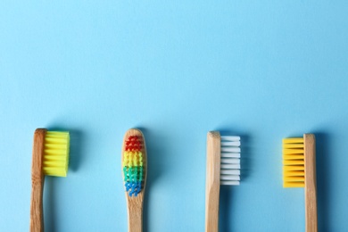 Photo of Different toothbrushes and space for text on color background, top view