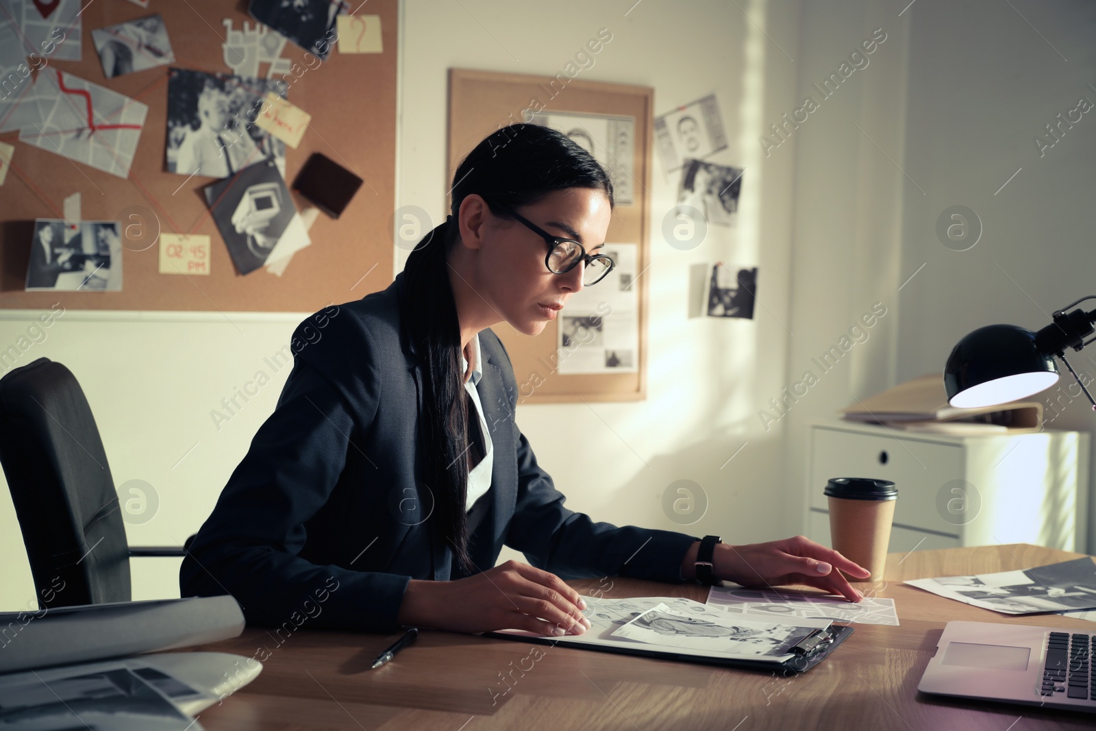 Photo of Detective working at desk in her office