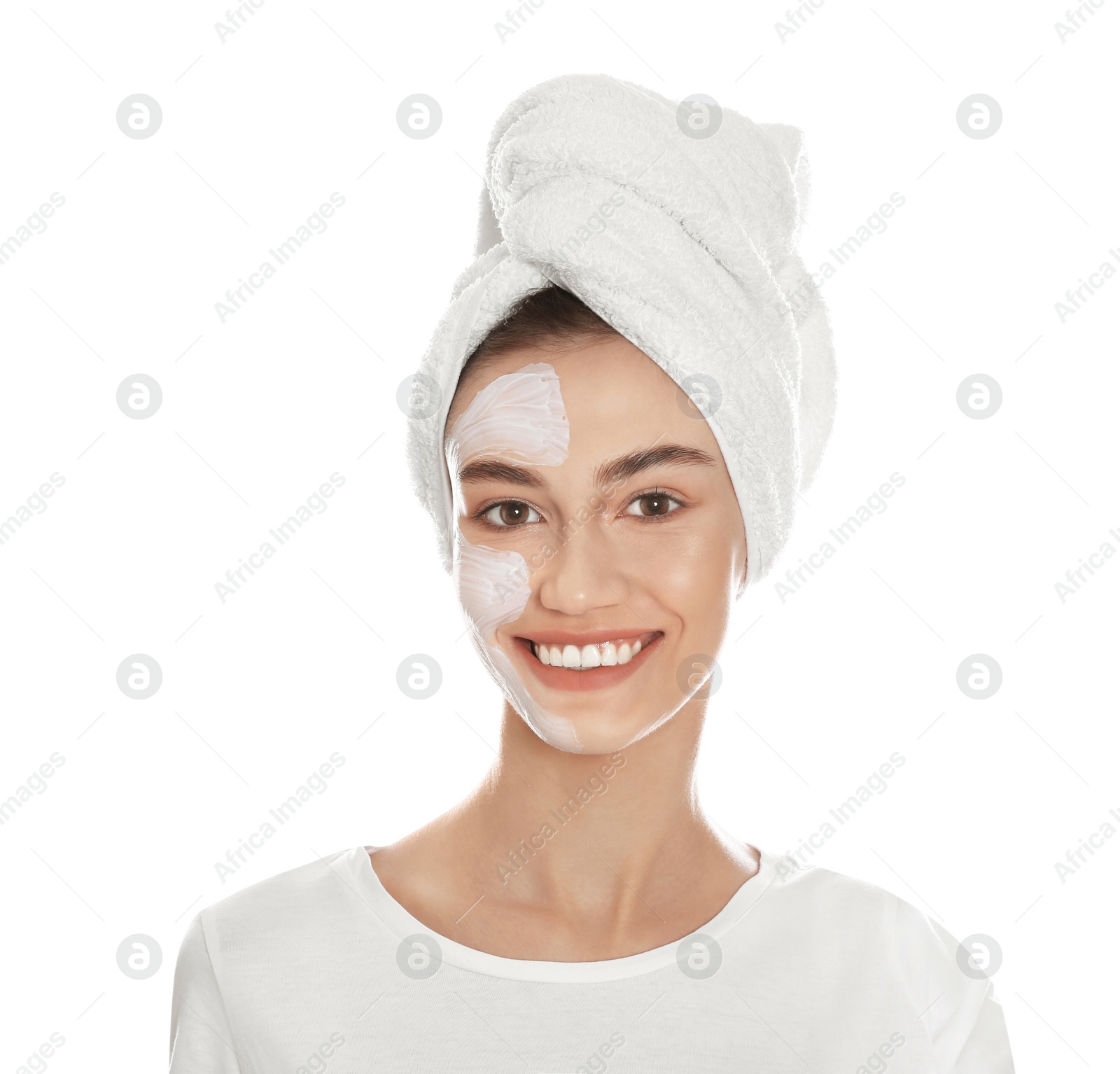 Photo of Happy young woman with organic mask on her face holding avocado against white background