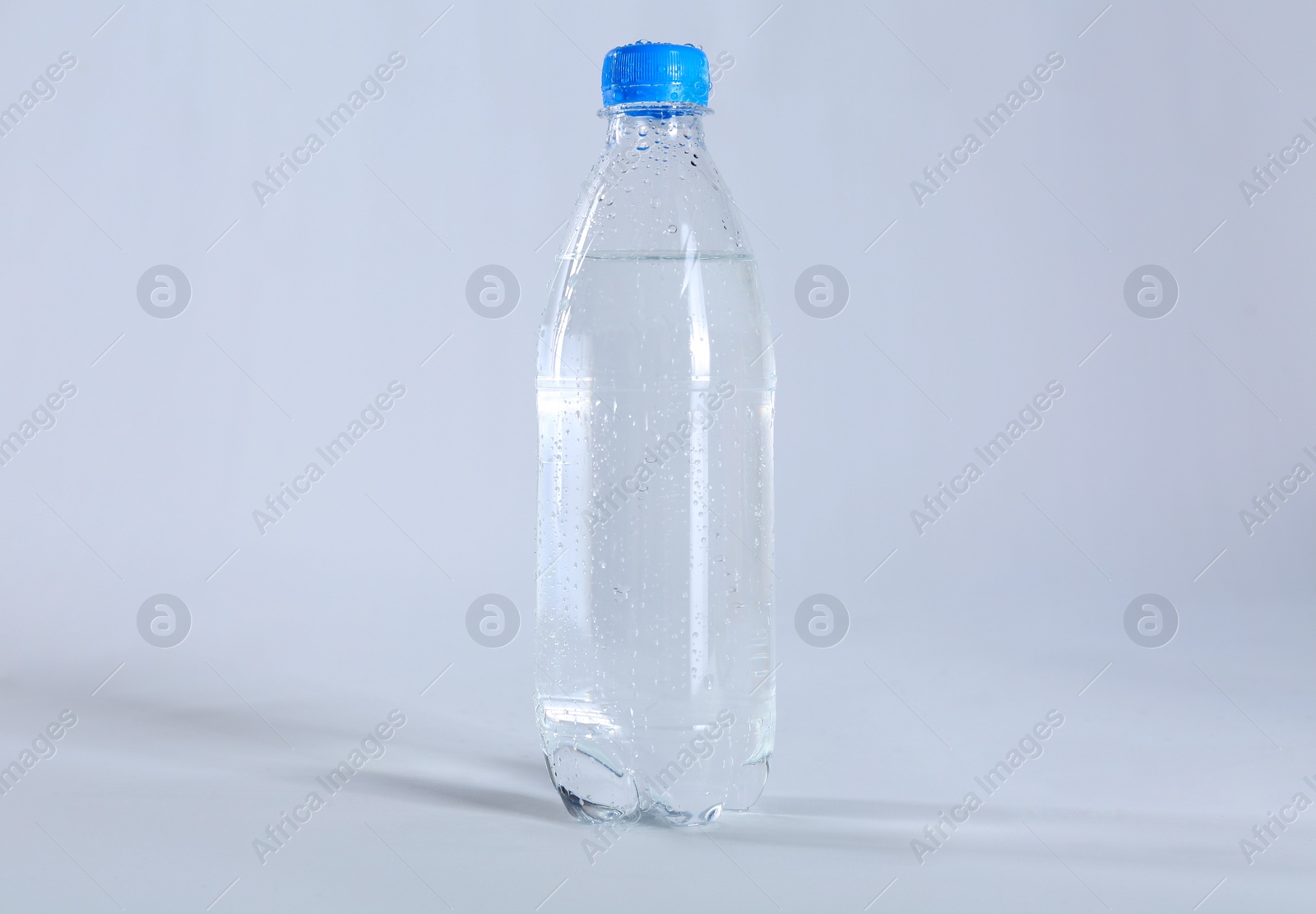 Photo of Plastic bottle of pure water on light background