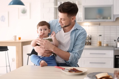 Photo of Dad and son at table in kitchen