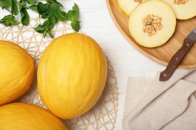 Photo of Flat lay composition with sliced ripe melons on wooden background
