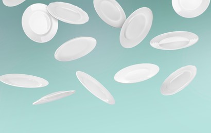 Image of Many white plates falling on pastel teal background