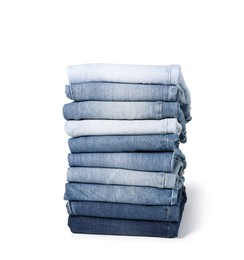 Stack of different folded jeans isolated on white