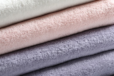 Photo of Stack of fresh folded towels as background, closeup
