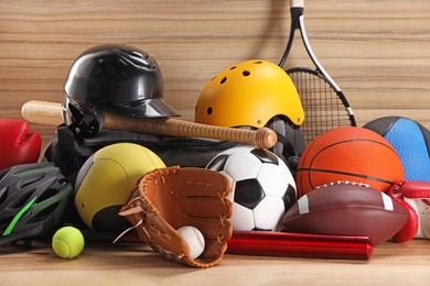 Photo of Many different sports equipment on wooden table