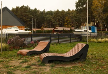 Photo of Recreation area with wooden sunbeds for rent outdoors. Real estate