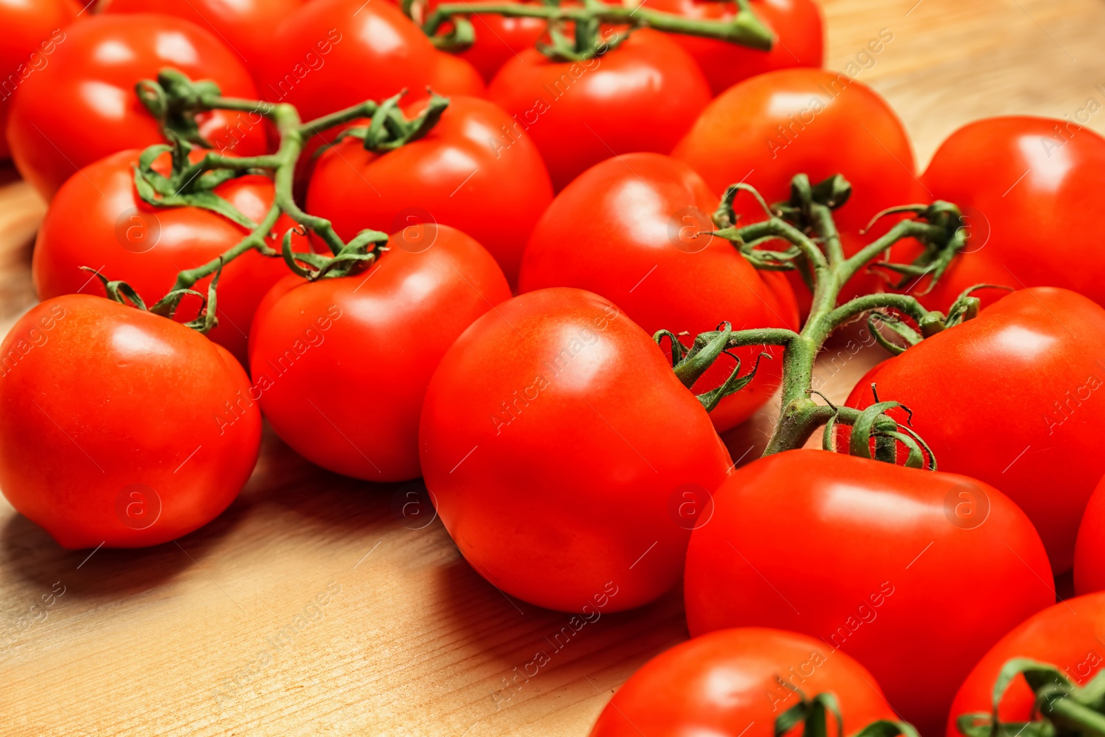 Photo of Fresh ripe red tomatoes on wooden table