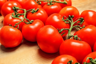 Photo of Fresh ripe red tomatoes on wooden table