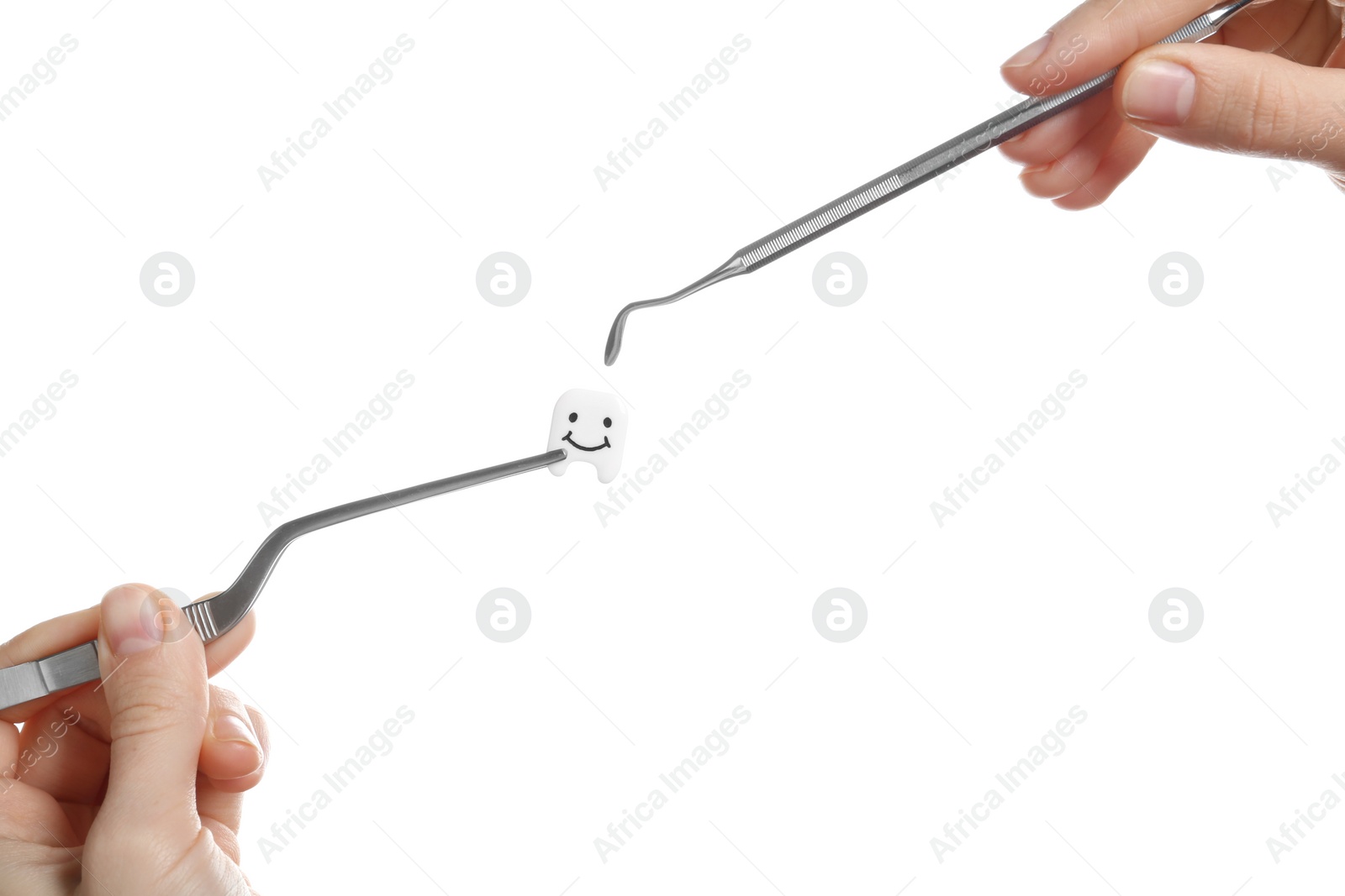 Photo of Woman holding professional dental tools and small plastic tooth on white background