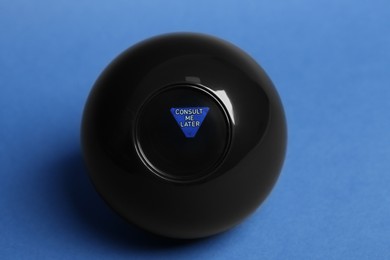Photo of Magic eight ball with prediction Consult Me Later on blue background