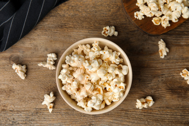 Tasty pop corn on wooden table, flat lay