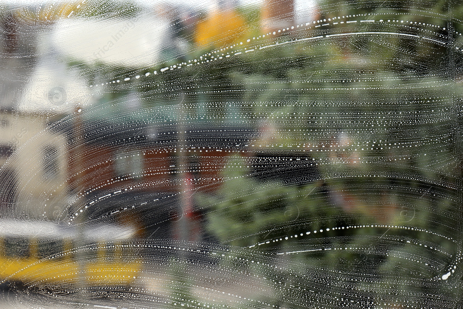 Photo of Cleaning foam on window glass, closeup view