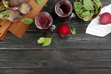 Photo of Fresh beet juice and raw vegetable on dark wooden background, flat lay. Space for text