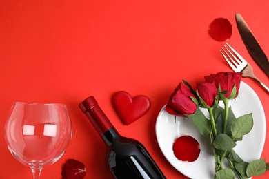 Photo of Romantic table setting on red background, flat lay with space for text. Valentine's day celebration